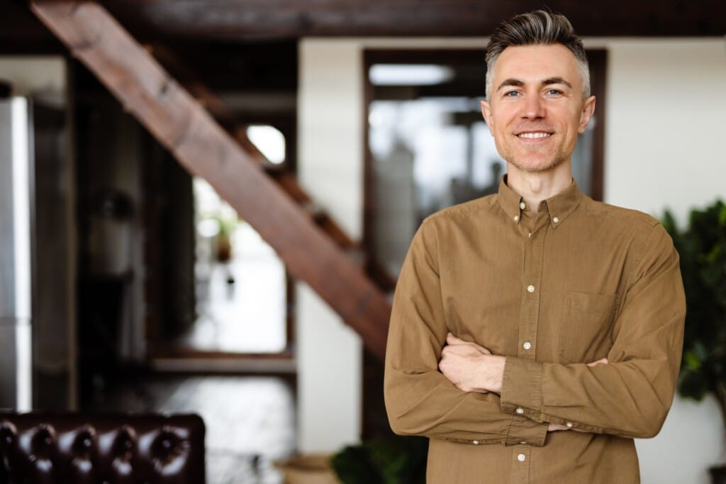 Smiling mid aged man holding a book