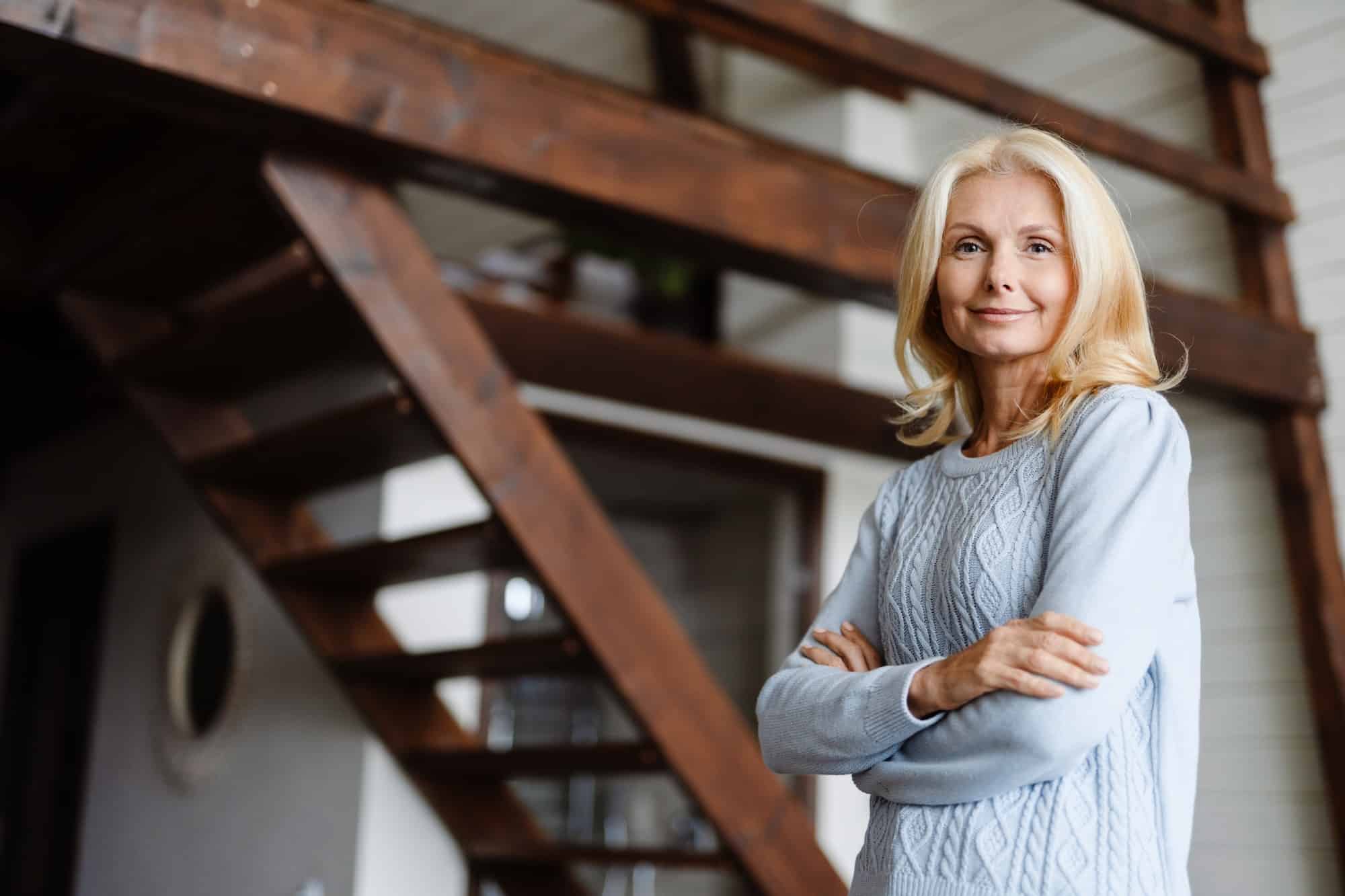 Smiling mid aged white blonde woman standing